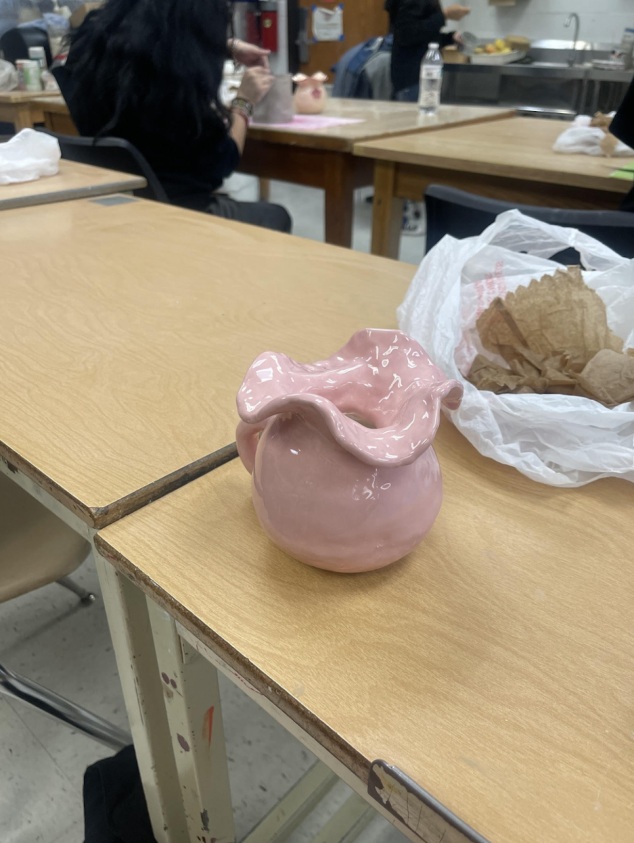 A student in the ceramics class displays a press mold project completed this year.